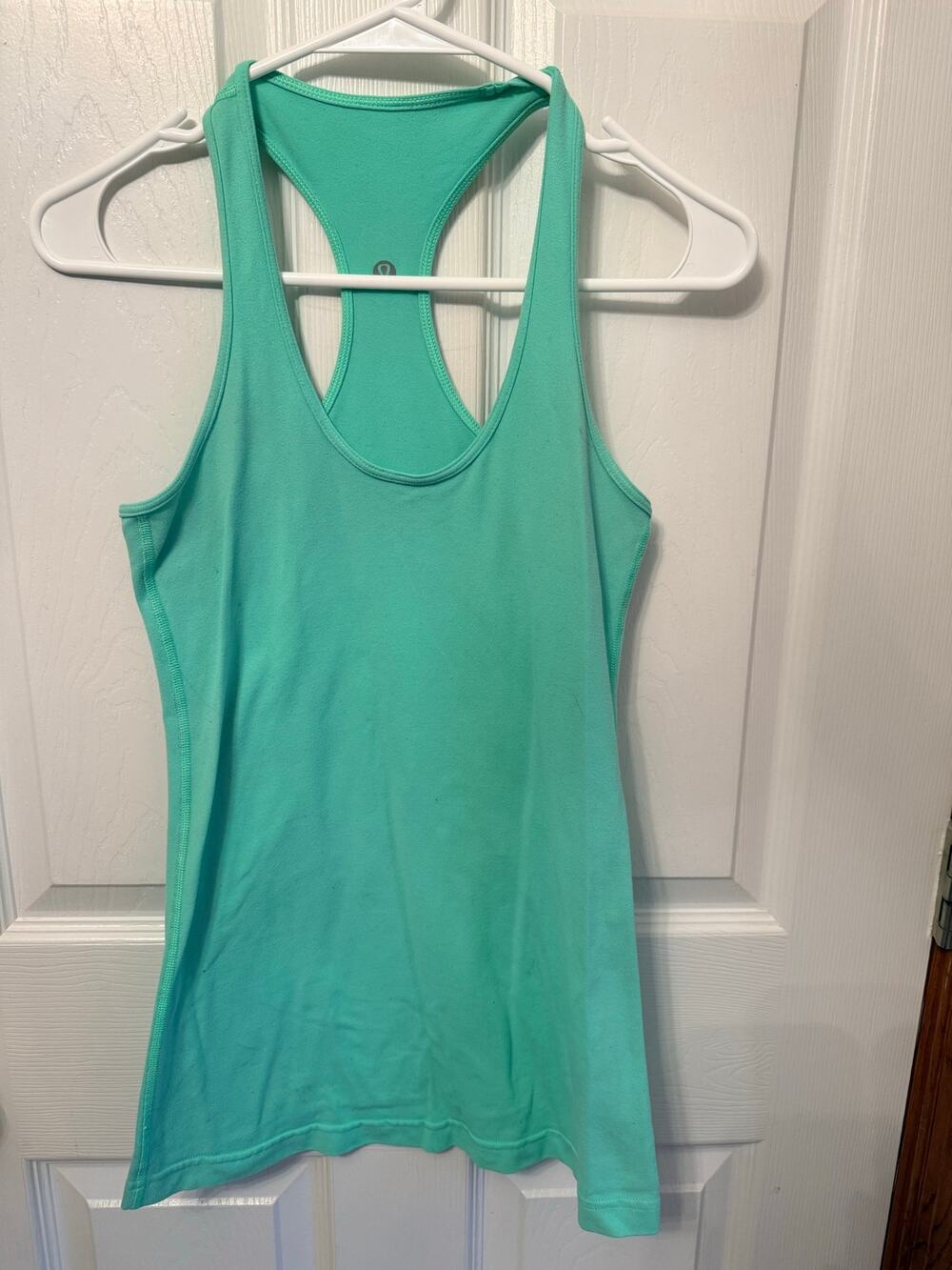 Teal Lululemon racerback workout tank top with the brand's signature logo